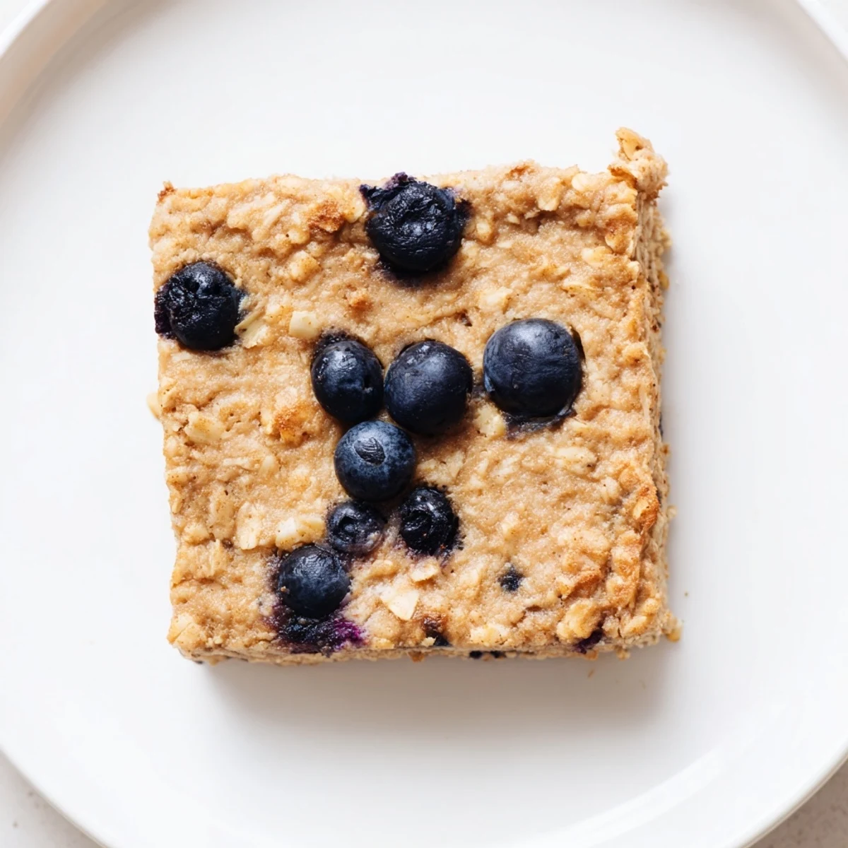 Fluffy Protein Pancake Oats, baked until golden, ready to be sliced and topped with fresh berries.