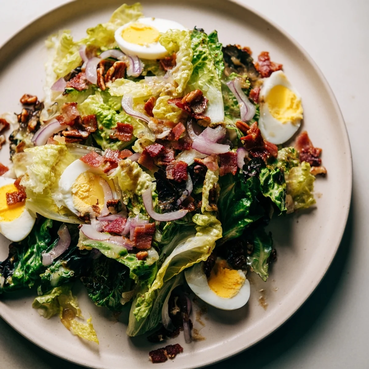 This vibrant Bitter Greens Salad features a flavorful warm bacon vinaigrette, a delicious and balanced meal.