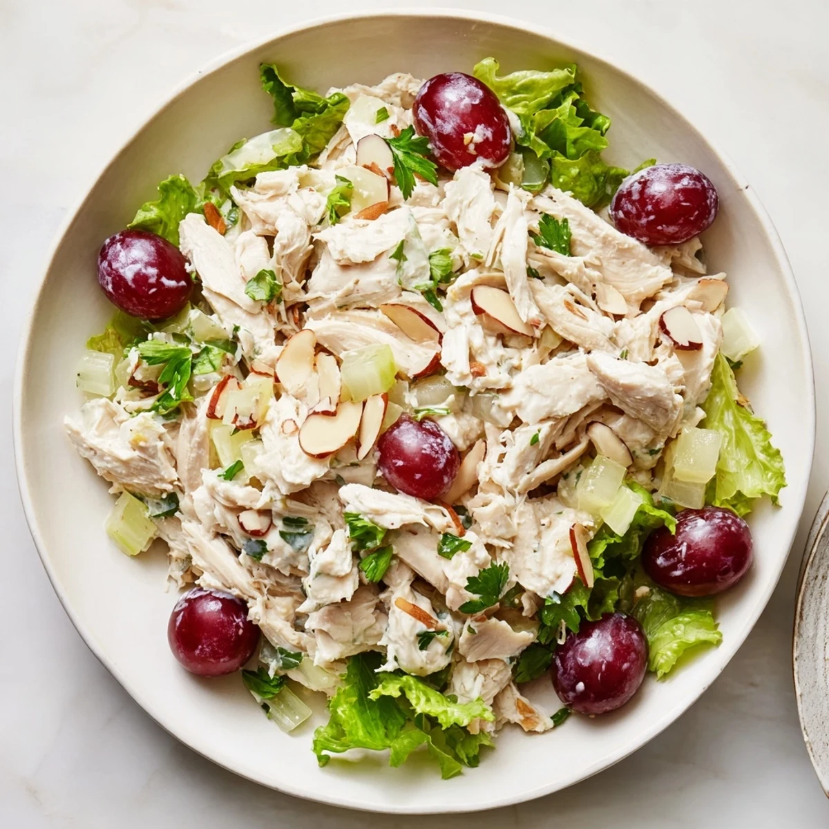 Enjoy a vibrant, healthy plate of Crispy Chicken Salad, boasting juicy grapes and fresh salad greens.