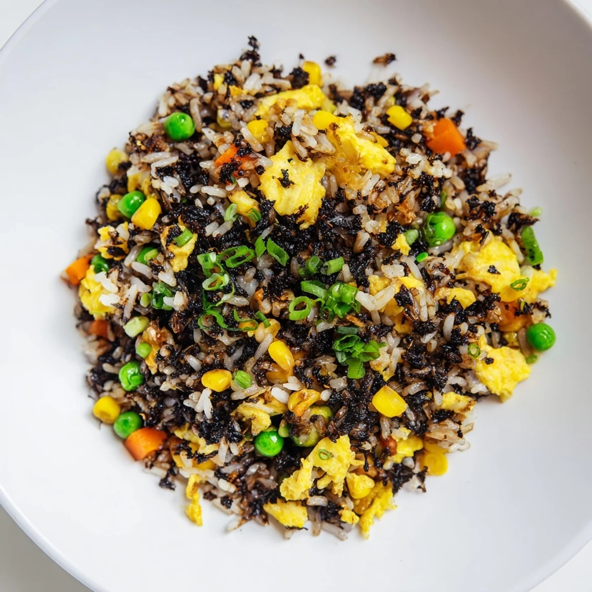 Hearty Asian fusion black garlic fried rice served family-style with kimchi on the side.
