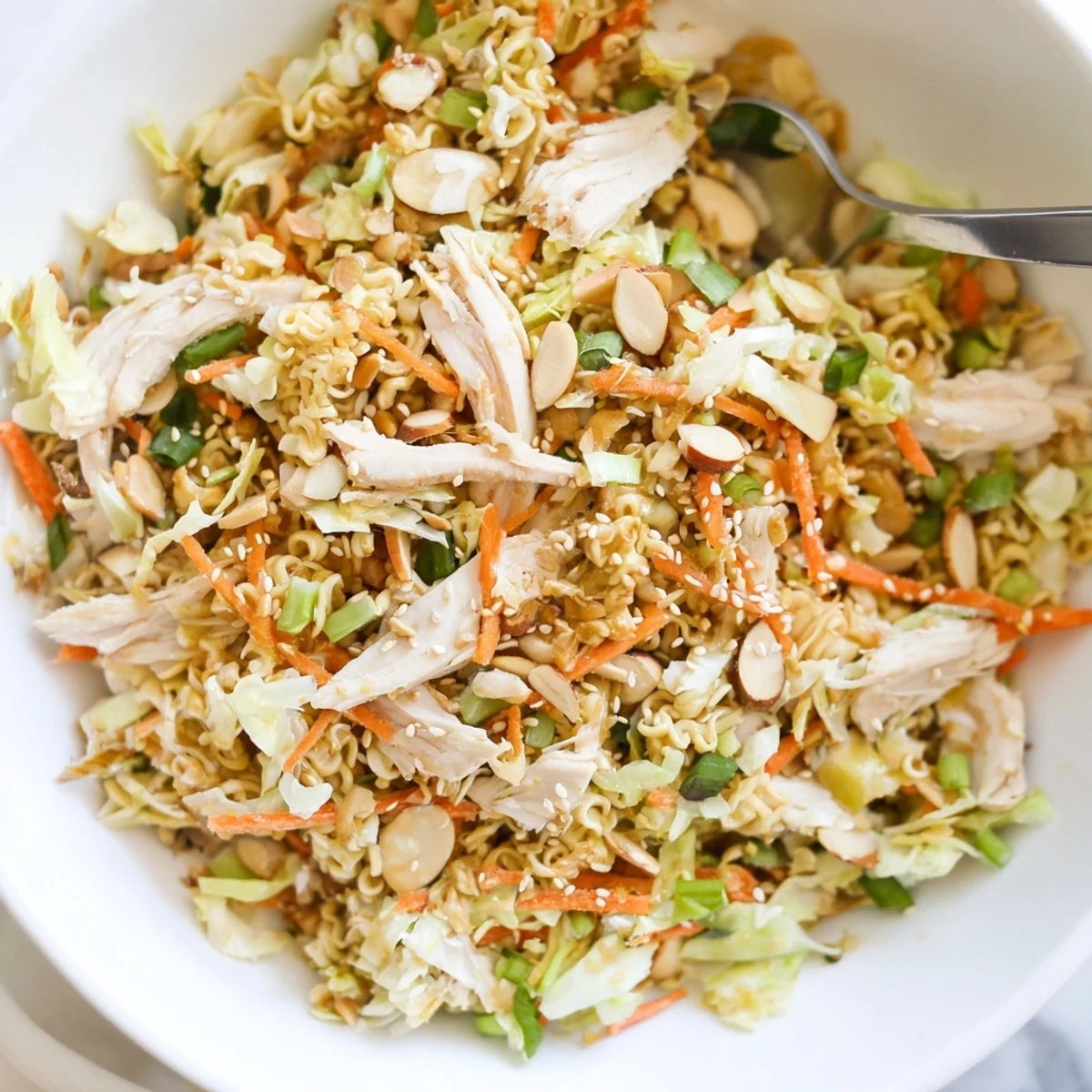 Colorful, easy Crunchy Ramen Chicken Salad featuring shredded vegetables, succulent chicken, and crunchy ramen noodles, perfect for a potluck or picnic.
