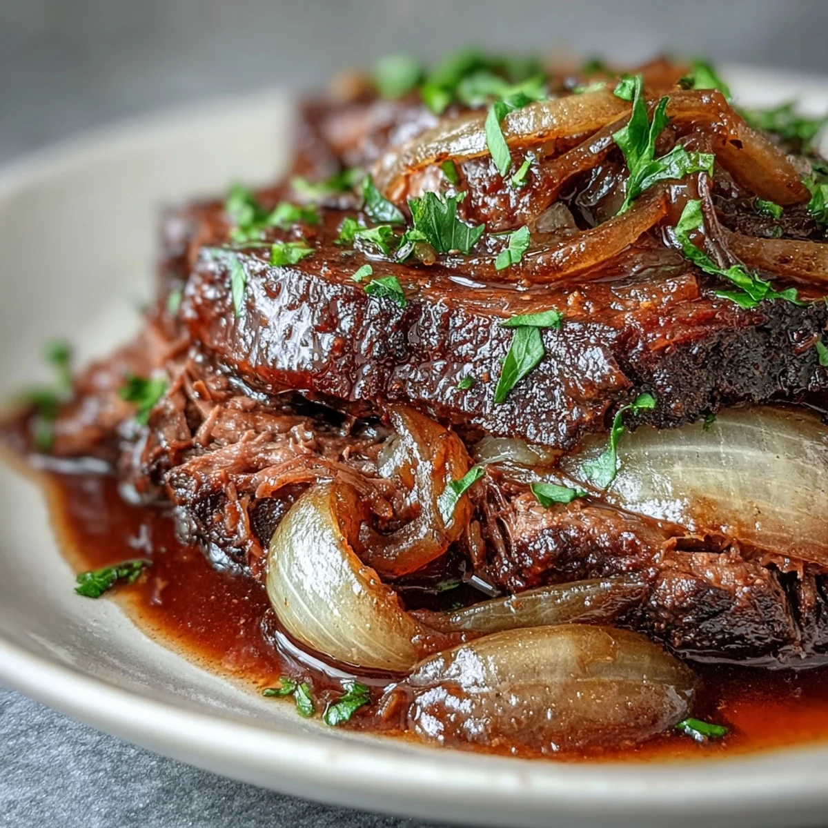 Savory Crock Pot French Onion Pot Roast served with crusty bread for dipping into rich, wine-infused juices.