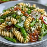 Vibrant spring pasta salad with lemon vinaigrette and crisp radishes, tossed with tender asparagus and sugar snap peas.