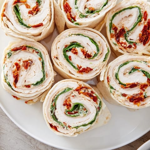 Vibrant image of easy Sun-Dried Tomato Turkey Roll-Ups filled with cheesy goodness, ready to eat.