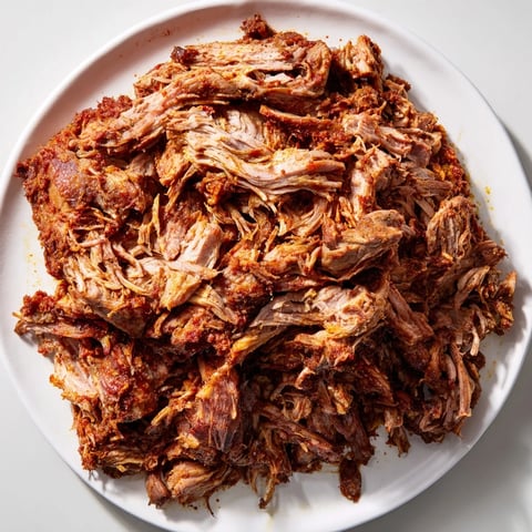 Tender Omani Shuwa, infused with vibrant spices, slow-cooked and ready to be shredded and enjoyed.