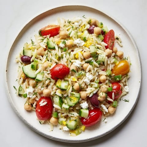 This Greek Lemon-Orzo Bean Salad is a vibrant mix of flavors that bursts with freshness in every bite.