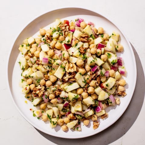 Enjoy a refreshing Fall Harvest Apple and Chickpea Salad with crisp apple chunks and toasted walnuts.