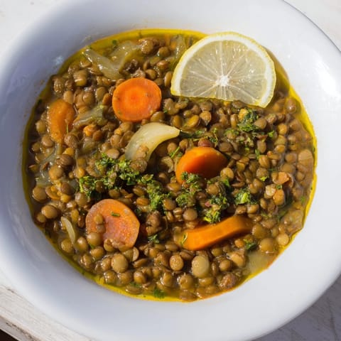 Enjoy a comforting serving of flavorful Middle Eastern Lentil and Chickpea Stew, ready to be enjoyed.