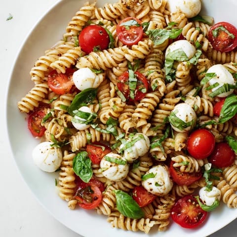 This Caprese Pasta Salad showcases colorful tomatoes, creamy mozzarella, and a bright balsamic dressing.
