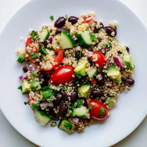 Chilled Quinoa Black Bean Salad boasting colorful bell peppers and avocado, perfect for a summer picnic.