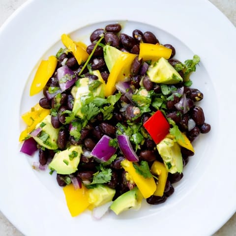 Freshly tossed Southwest Black Bean Salad, a vegetarian delight, ready to serve as a light meal.