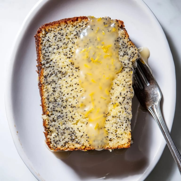 Freshly baked Glazed Lemon Poppy Seed Cake, showing a golden crust and a beautiful glaze on top.
