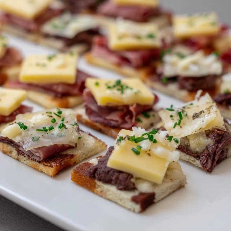 Vibrant Checkerboard Picnic Bites arranged on a platter; turkey, Swiss, cheddar, and roast beef.