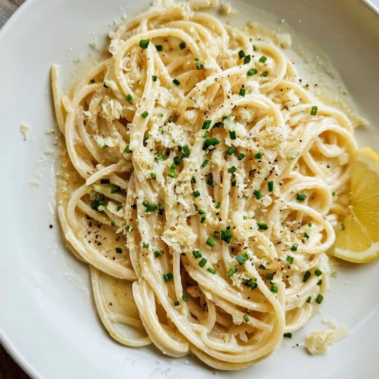 A close-up of miso butter pasta, highlighting the umami flavor and vibrant green scallions.