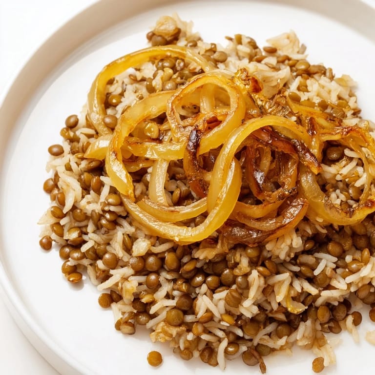 Close-up photo of steaming Lebanese Mjadra, with fluffy rice and tender lentils, ready to serve and enjoy.