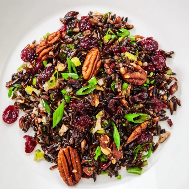 Bright autumn Wild Rice Harvest Salad in a white bowl, featuring green onions, diced apple, and glistening vinaigrette.